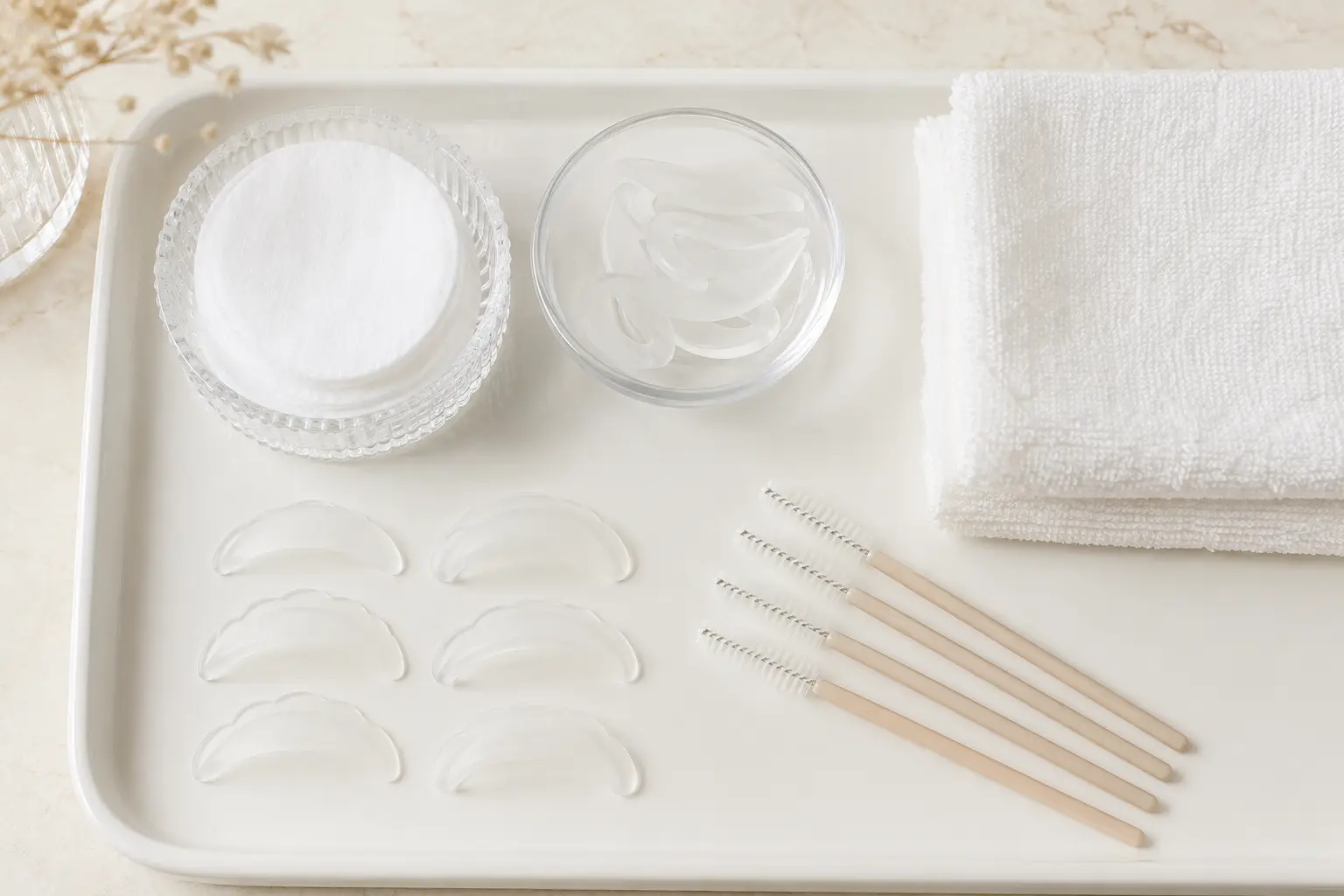 Clean lash lift preparation tray with silicone shields and spoolie brushes