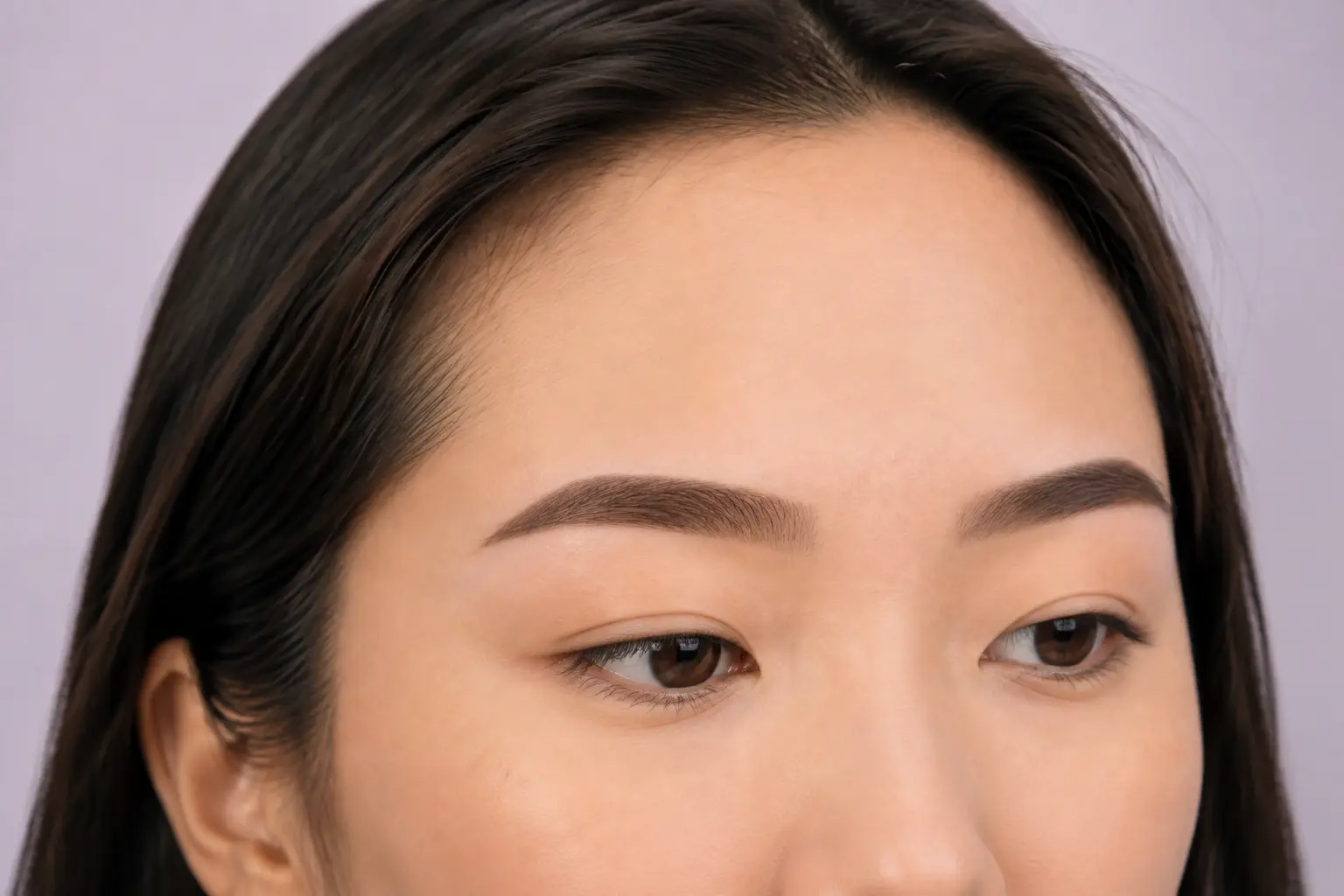 Three-quarter view of straight softly shaded powder brows