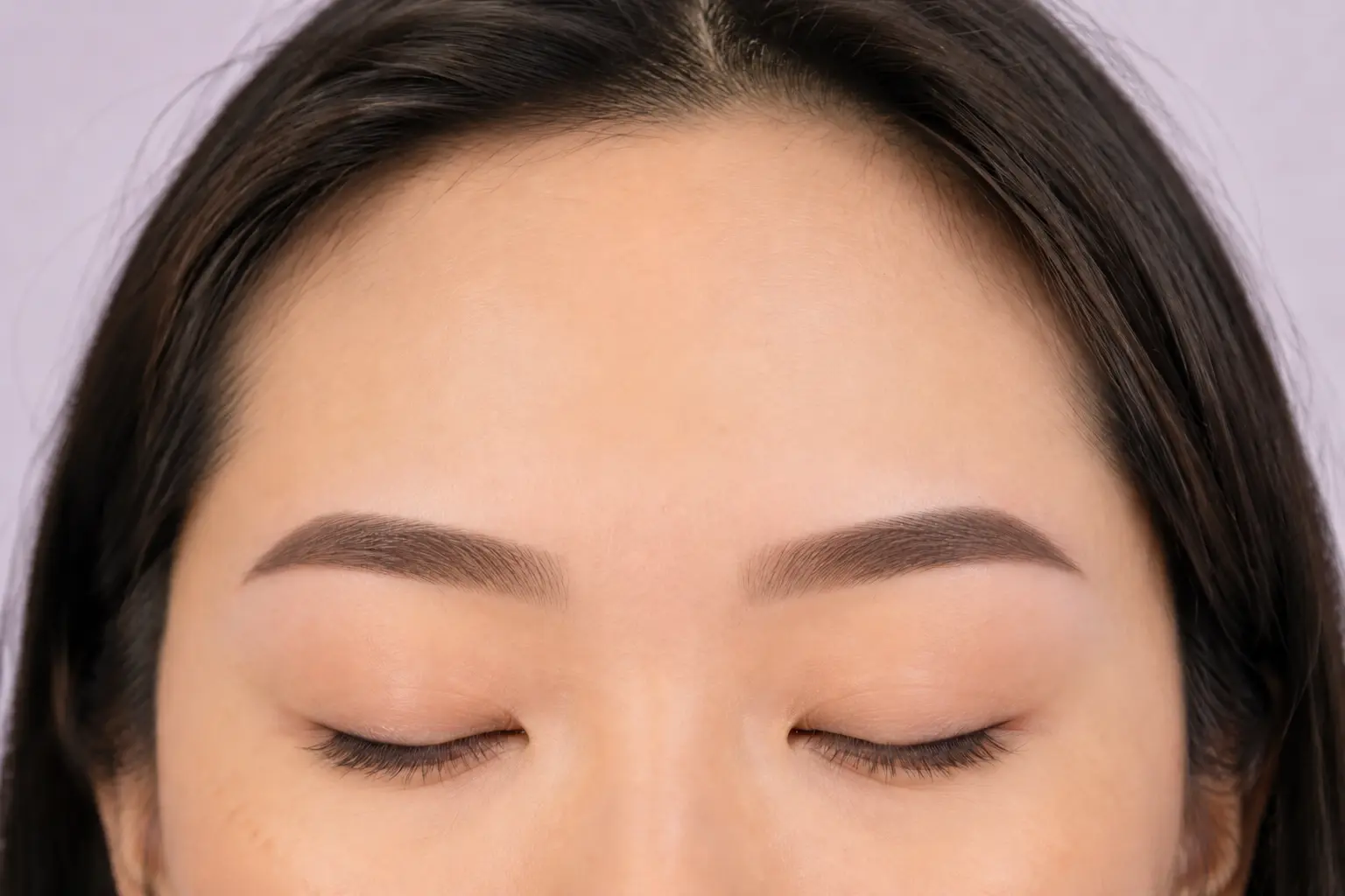 Softly shaded straight powder brows with lighter fronts and tapered tails